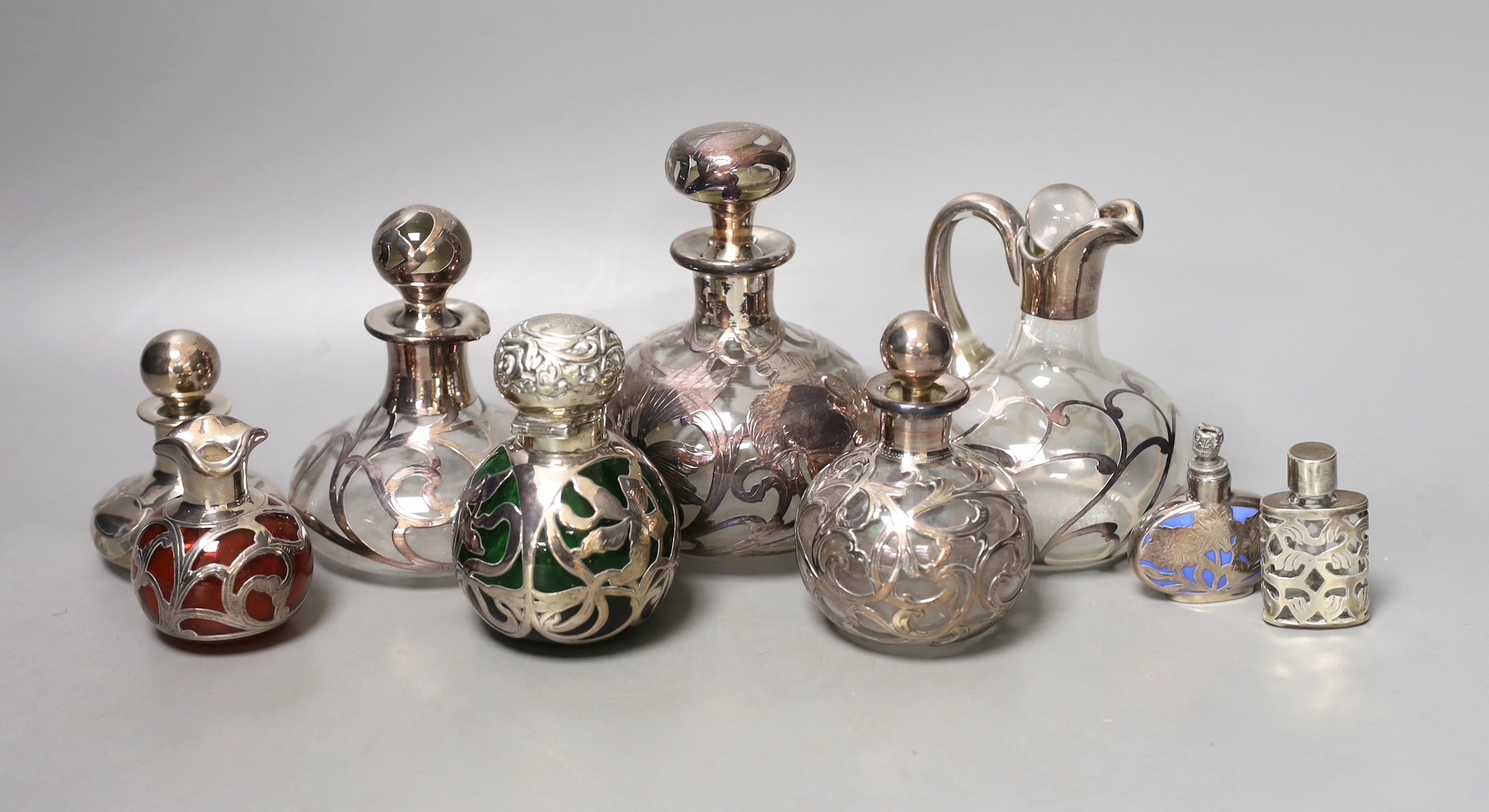 A group of white metal jacketed scent bottles, jugs etc (group)